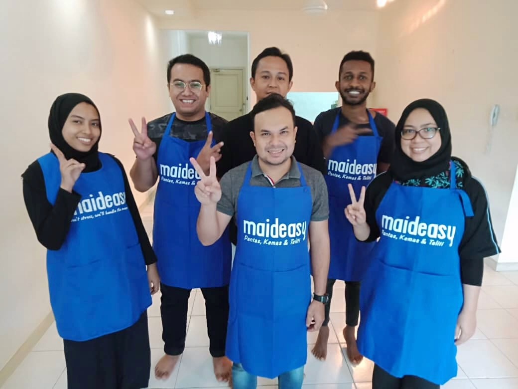 Maideasy cleaning team smiling together in blue Maideasy aprons